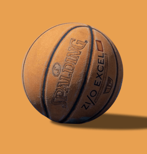 Orange basketball with black seams on a solid orange background.